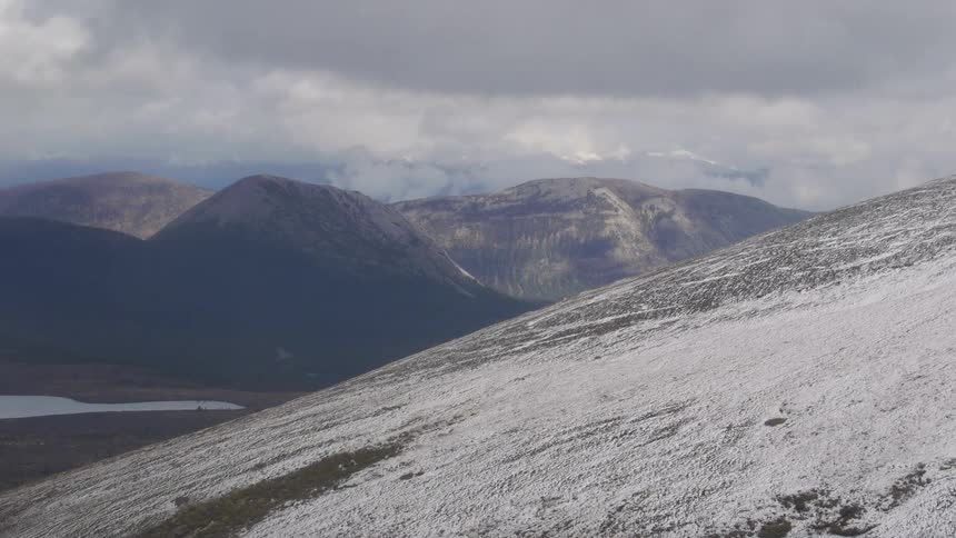 View of clouds hovering over mountains