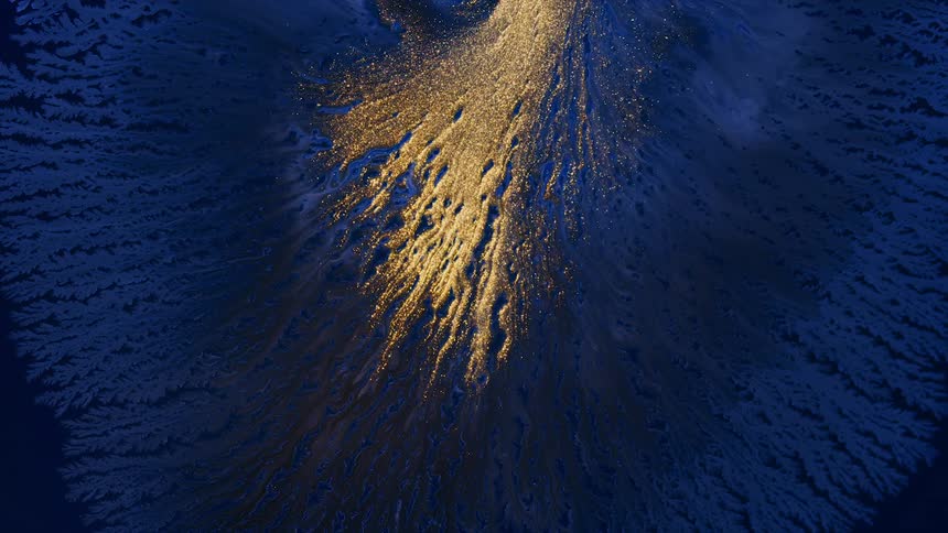 A close up of an orange liquid shooting in