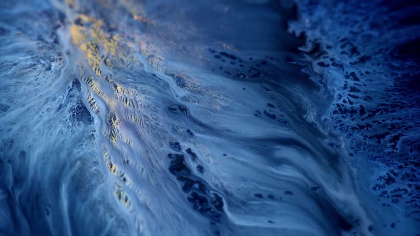 White blue gold and black colors that look like a river in the mountains