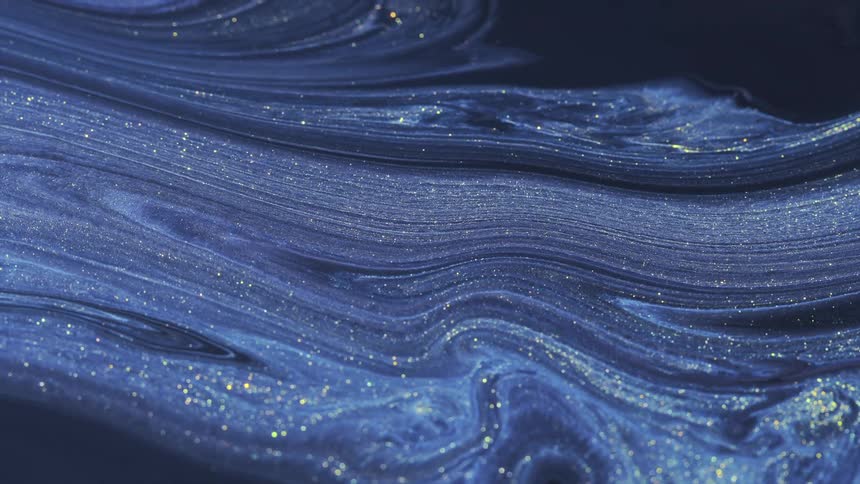 A close up of liquids mixing and moving in thin lines