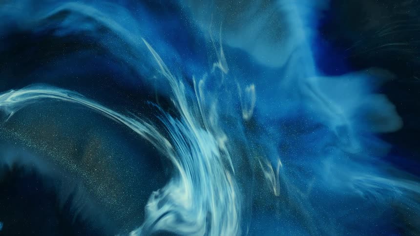 White and blue swirl flows across darker blue and gold glitter background