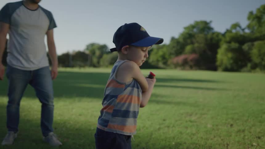 Father and son playing tee ball