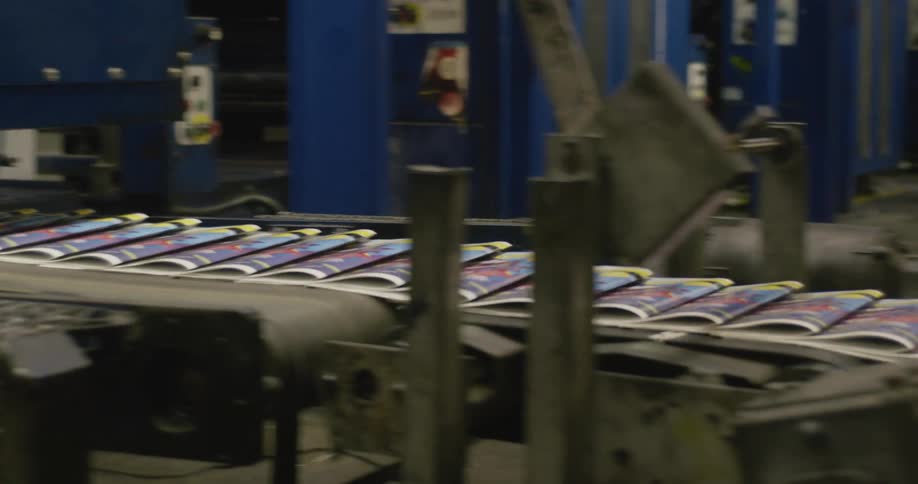 Colorful folded paper moves down a machines conveyor belt