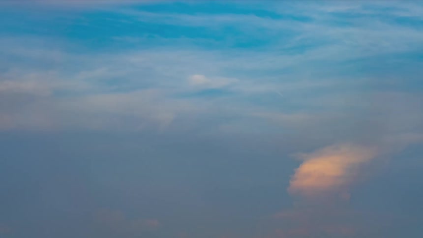 Time lapse of clouds moving on a blue sky at evening