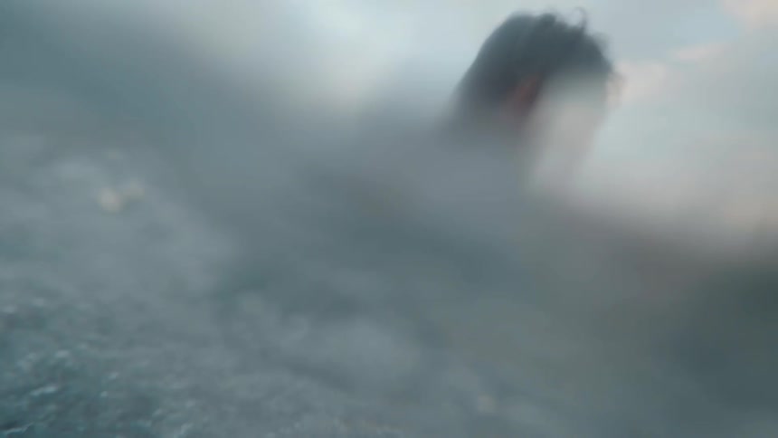A man surfing on a wave in the ocean