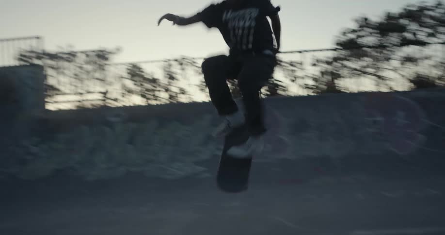 A boy does a trick on his skateboard