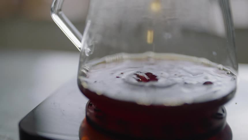 A beverage is being poured into a cup