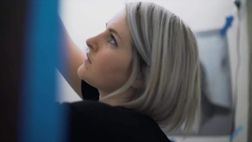 A woman is working reaching up