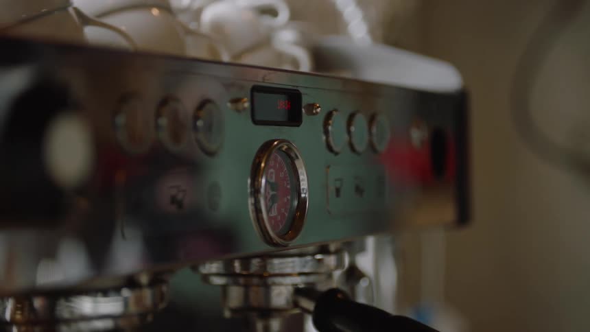 Commercial espresso machine with buttons and a display