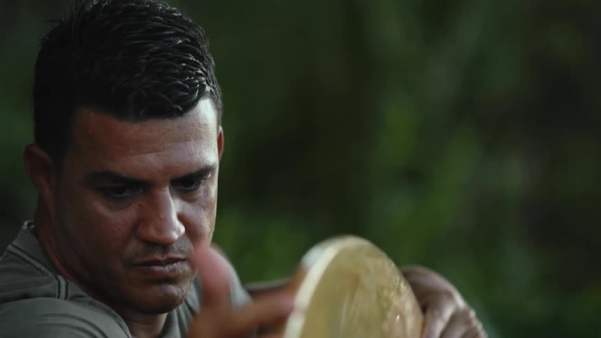 A man looking at a board outdoors