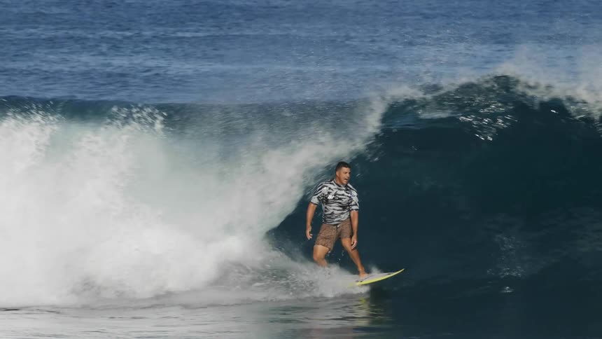 A man is surfing on waves in the ocean