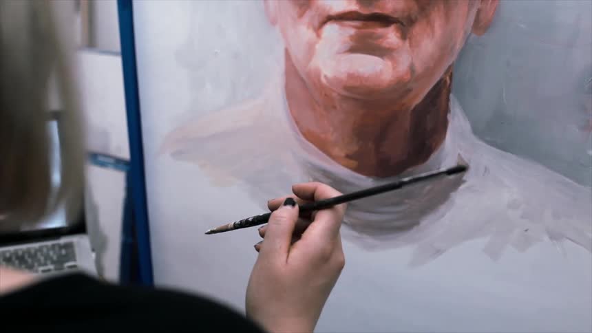 A person is painting a portrait