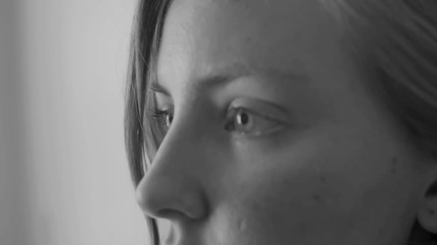 A woman stares ahead