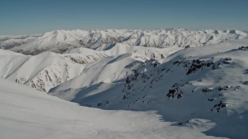 An aerial view of snowy mountains in the wilderness