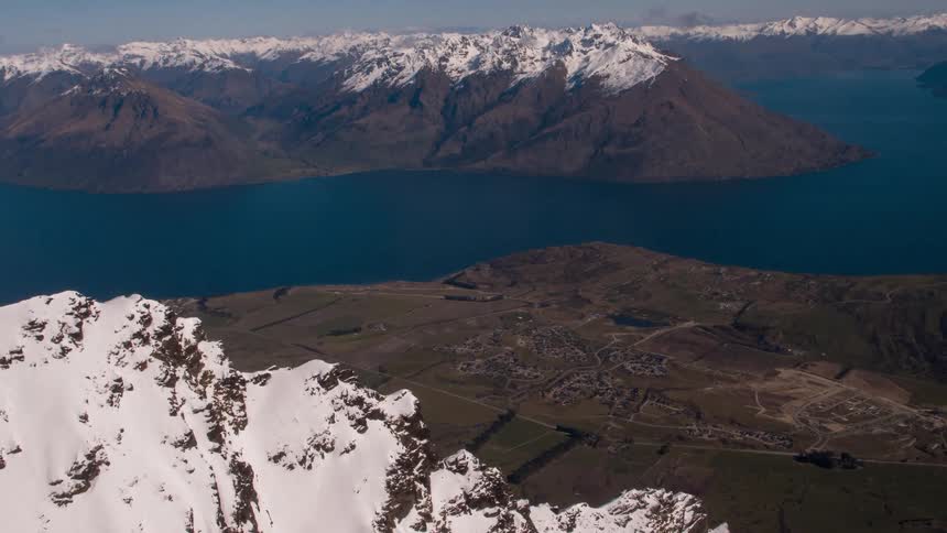 Snow capped mountains surround a blue lake