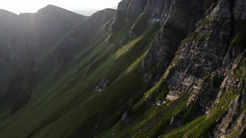 An arial view of a moutain range shows the cliffs and rocks lining the steep sides