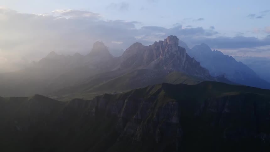 Clouds floating over a mountain range at sunrise
