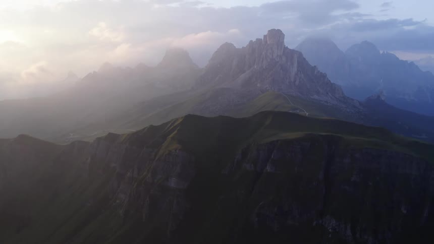 Fog rolls into mountaintops as the sun starts to rise