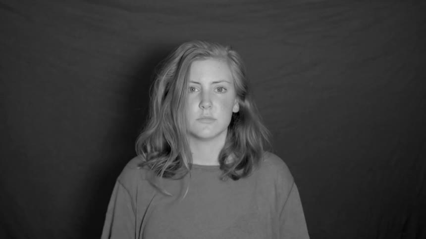 A woman looks up and a curtain behind her falls away
