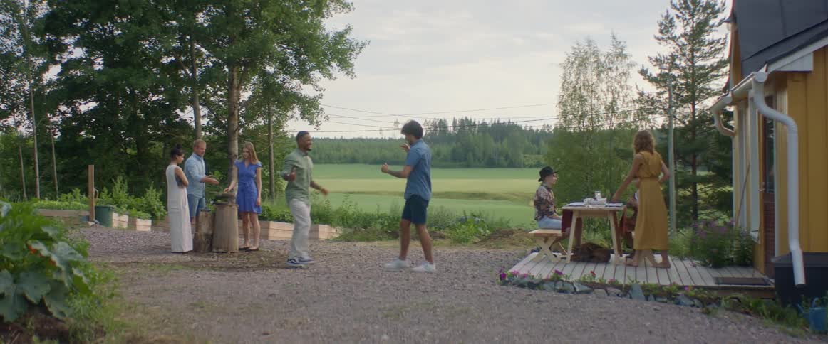 Friends greeting each other with hugs in a party on the countryside