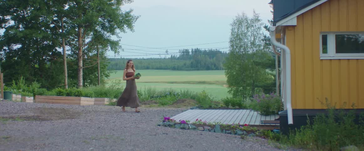 A woman working in a garden outdoors