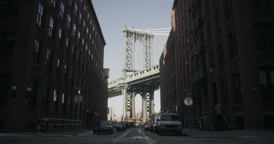 View of a side street with a bridge in the background