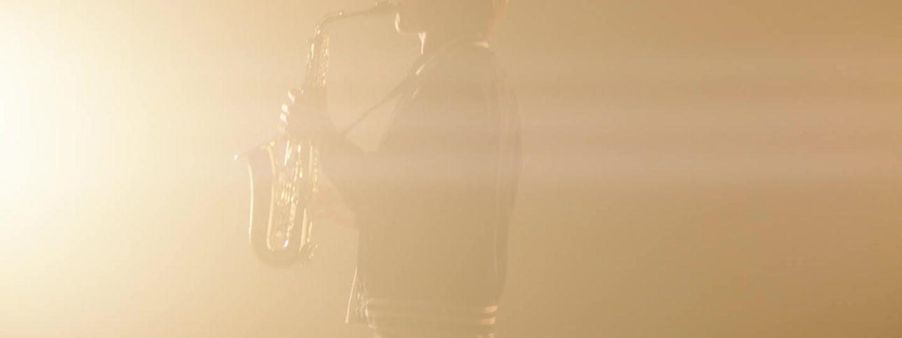 A man playing a saxophone on a stage