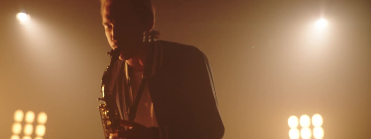 A man playing a saxophone on a stage