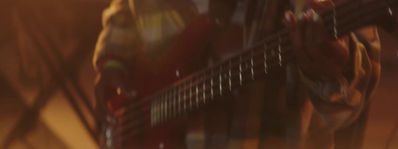 A person on a stage playing a guitar with spotlights and a wall in the background