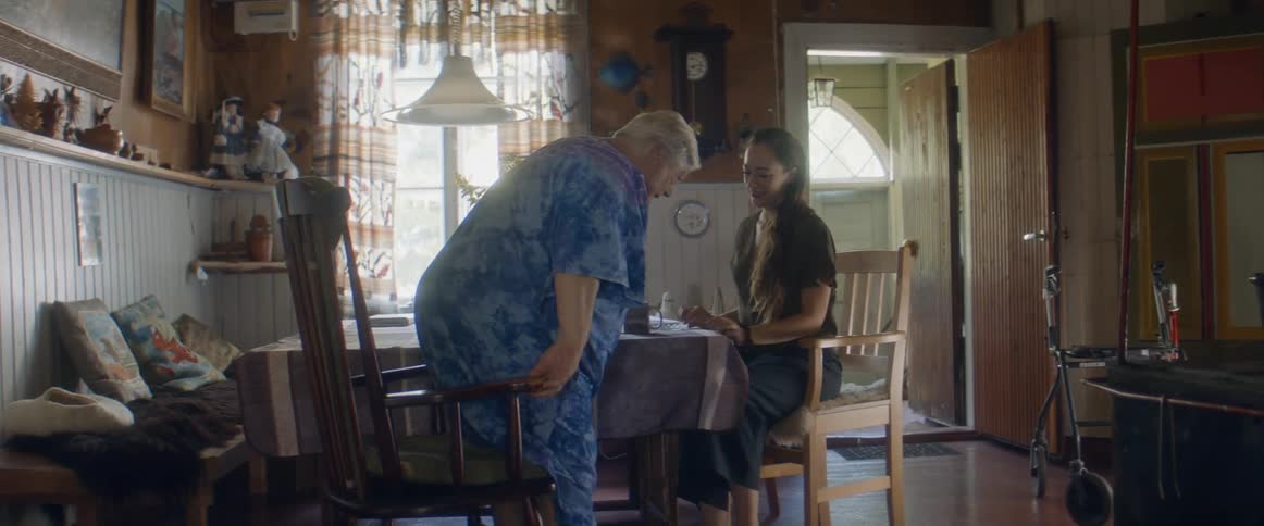 Two women sit down at the table to talk