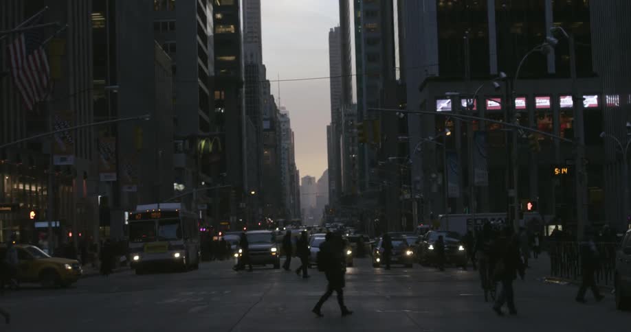 People are crossing a busy intersection