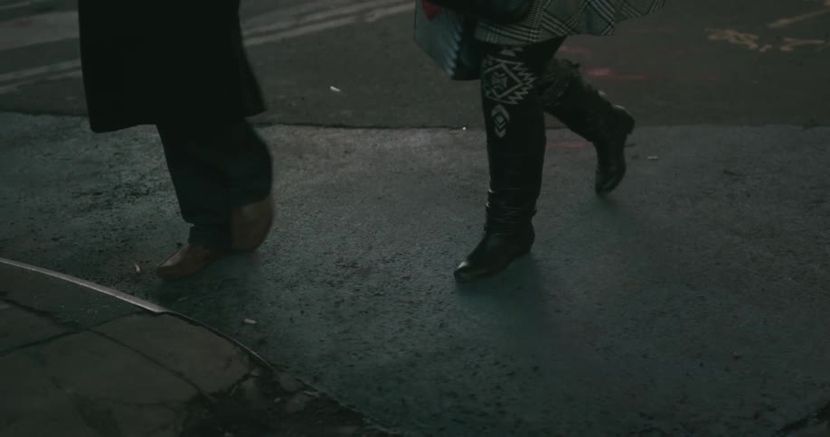People cross a street over to a curb