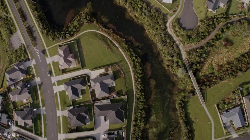 A neighborhood with houses roads trees and vehicles