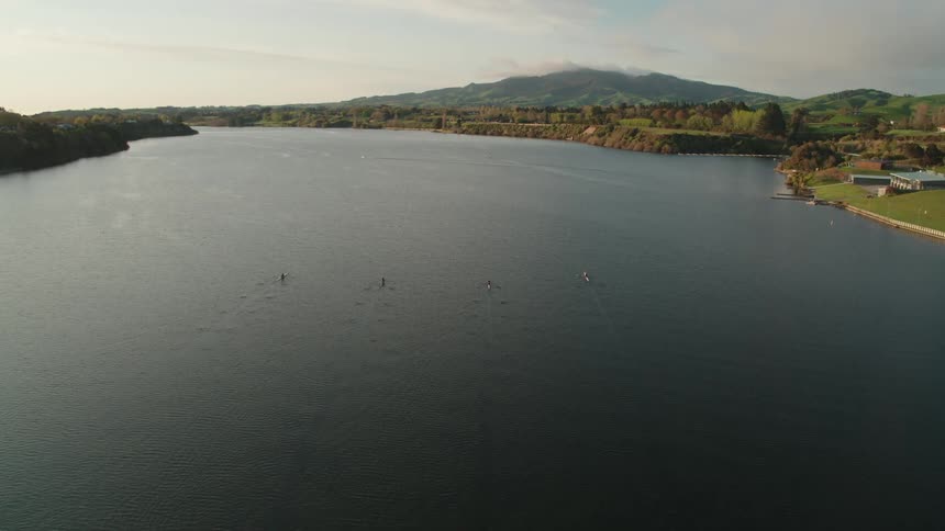 Kayakers ride side by side as they make their way down a wide river