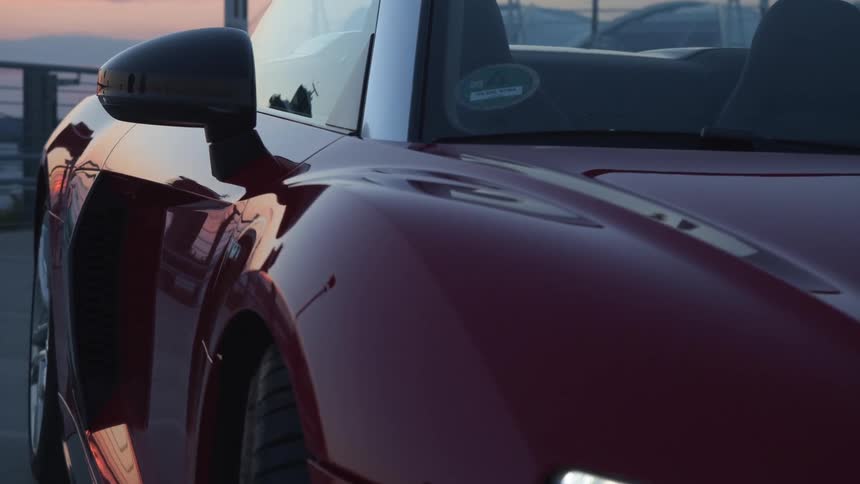 A sportscar is sitting on top of a parking deck