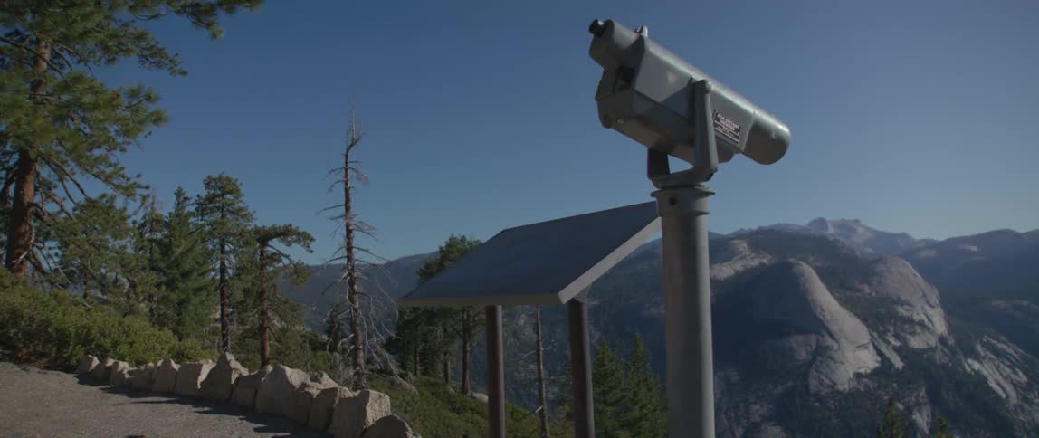 Telescope on a post near the mountains