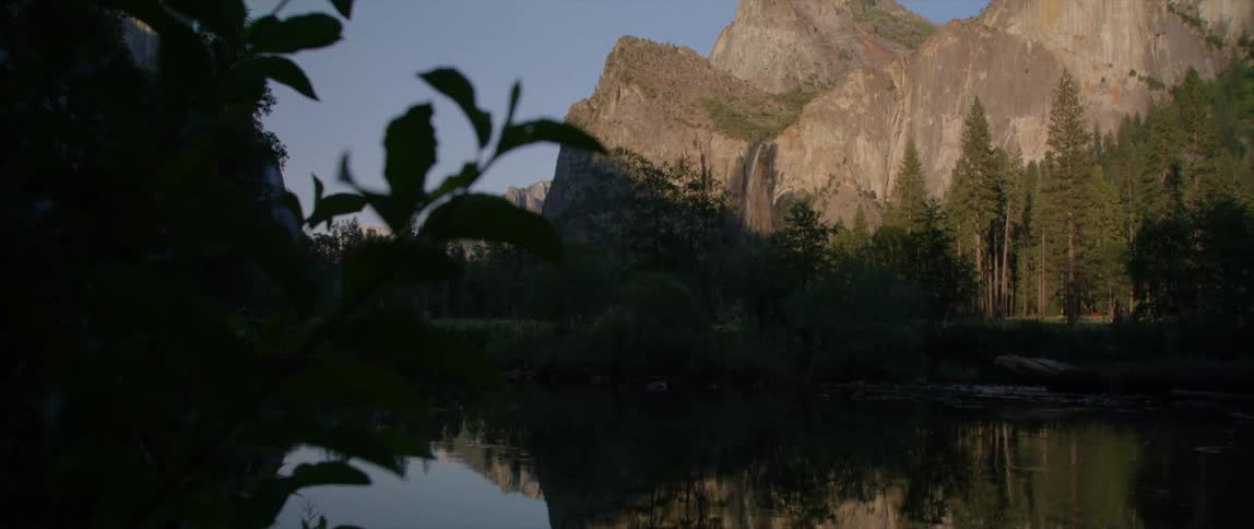 Mountains and trees reflecting in lake water