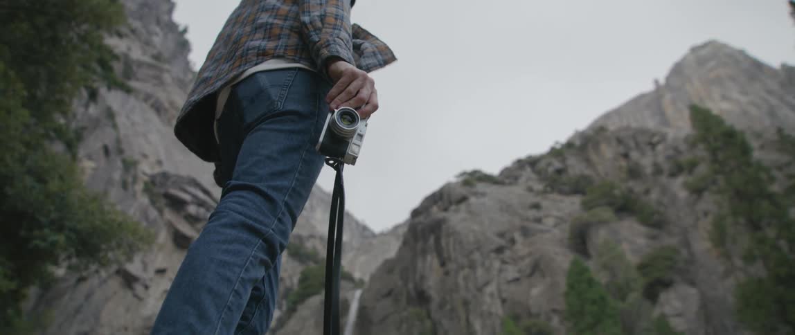 A photographer standing outdoors in nature