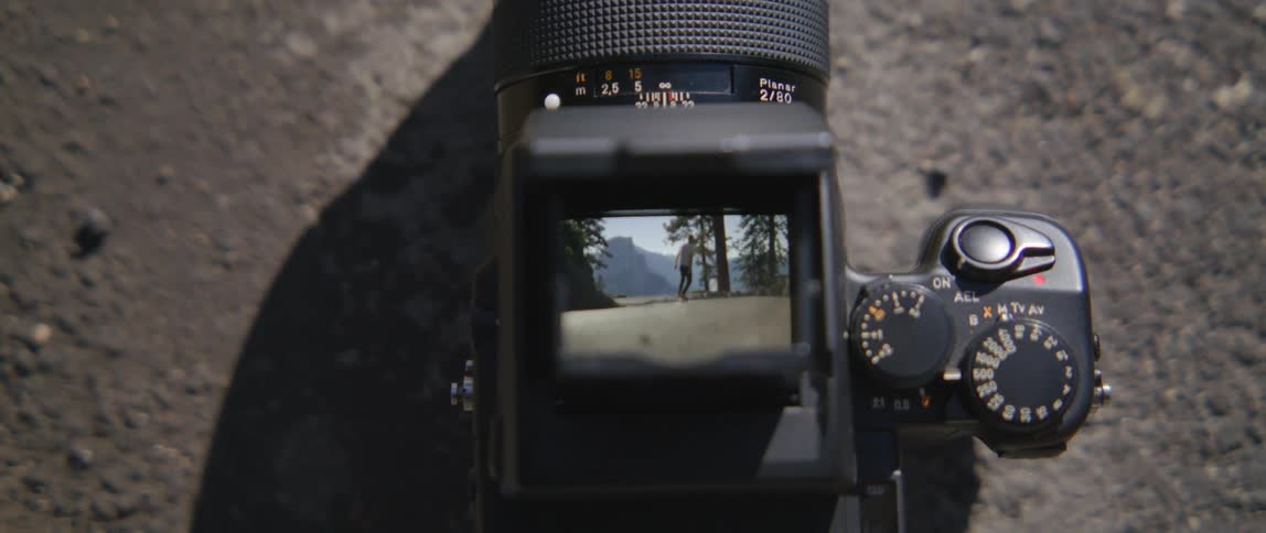 A camera with its viewfinder showing a person on a skateboard