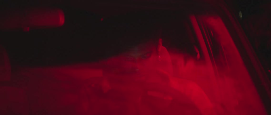 A man sitting in a vehicle with a steering wheel