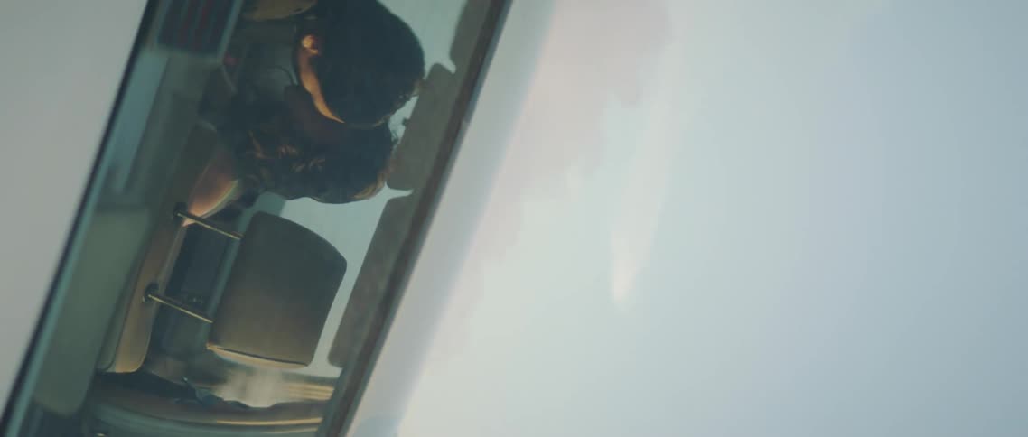A man and woman kiss one another in a car
