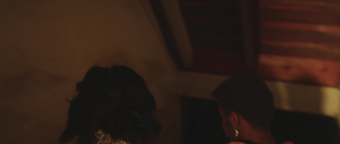 A man leads his girlfriend by the hand as he walks through his kitchen and downstairs to a basement