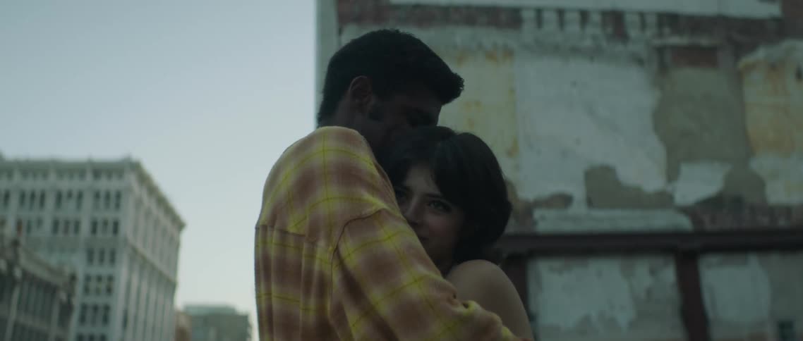 Two people hugging in a city