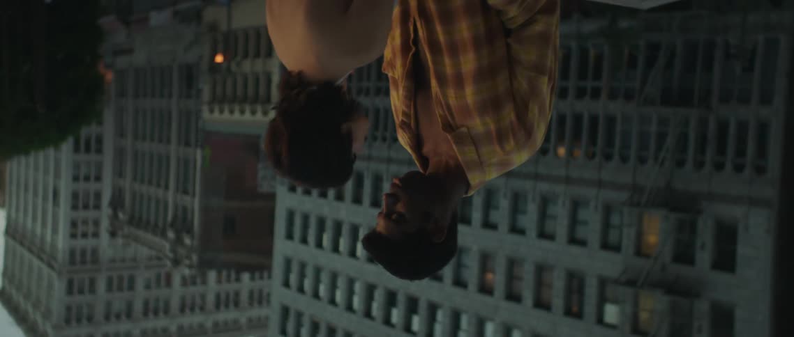 A couple stand together on the roof