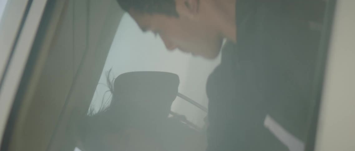 A view of a man and woman in a car rotating