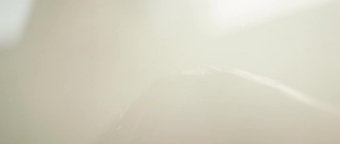 Moving hand of a young woman sitting inside a parked car surrounded by smoke at evening