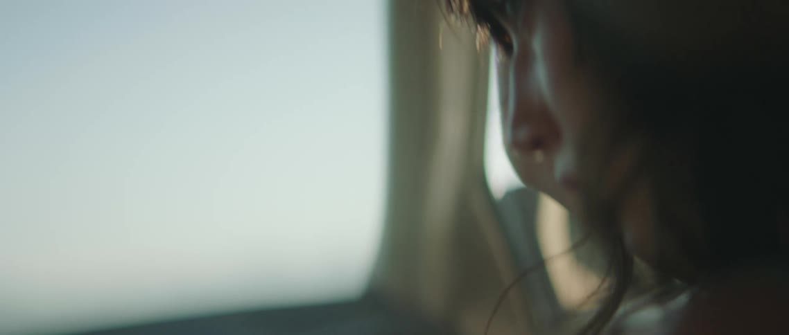 A woman is sitting in the passenger seat of the vehicle