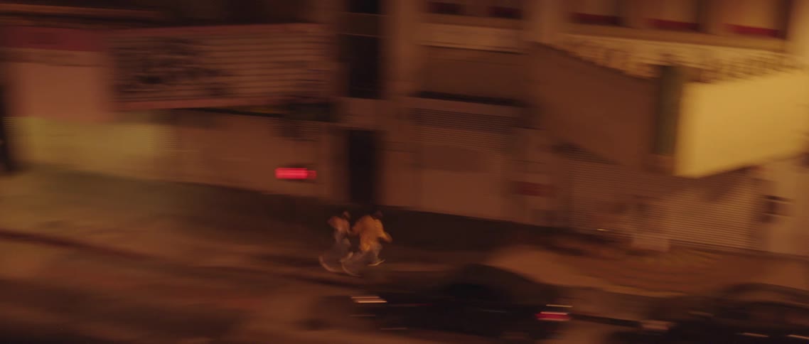Couple running down alley