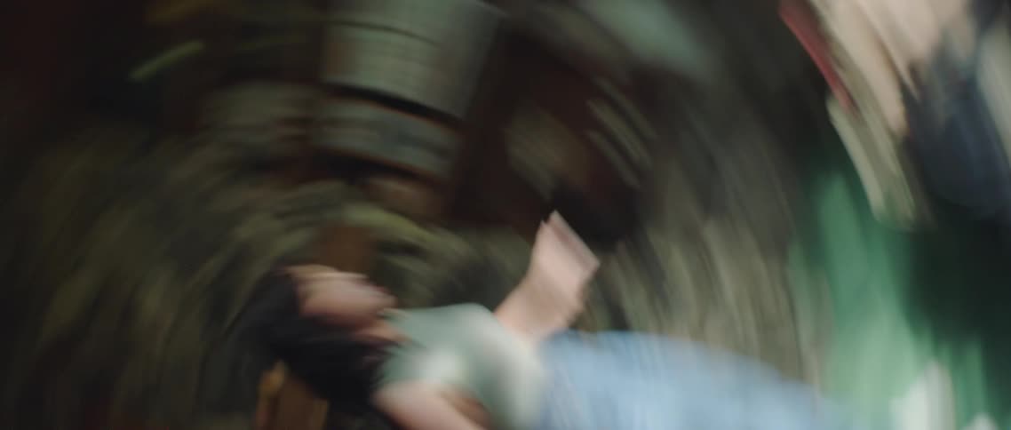 A woman is dancing in a darkened room