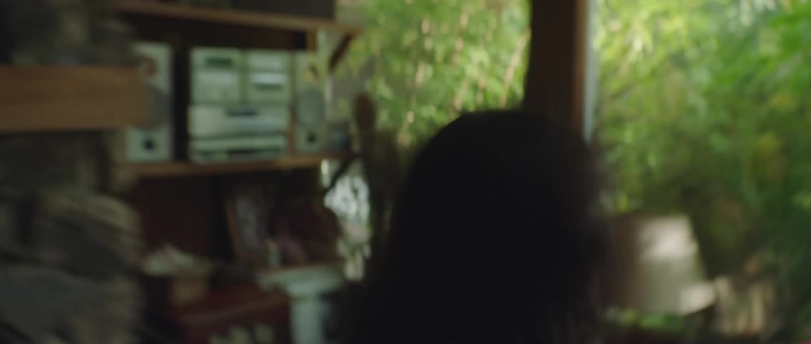 A woman is yelling at a man sitting on the couch